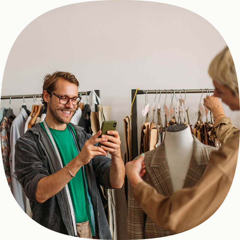 Happy customer shopping for fashion making a payment on their mobile device